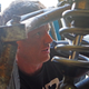 Caswell peeking around his beloved “Baja Pig” off-road beater. (Photo Credit: Andrew Collins)